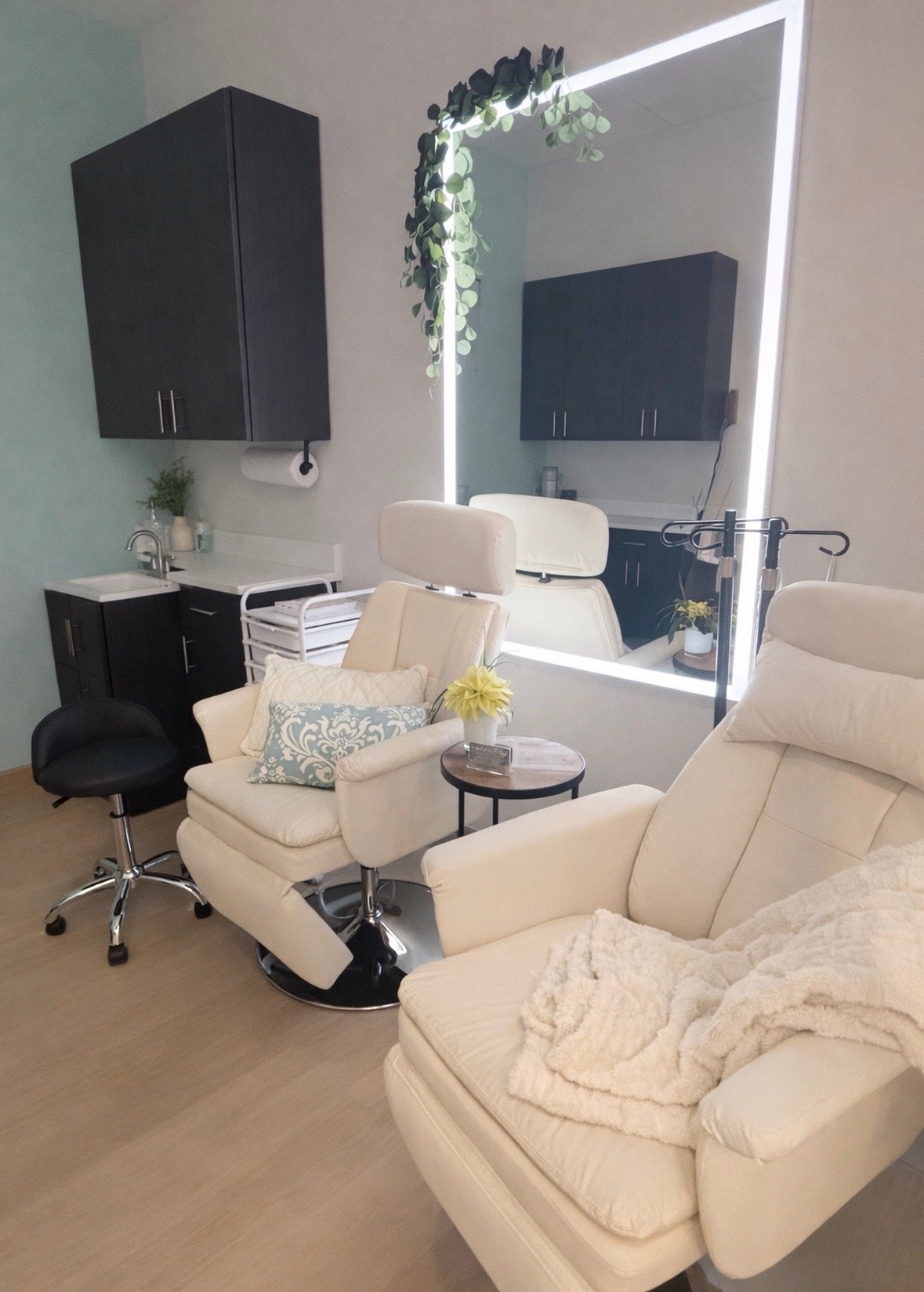 Private cream treatment recliners beside a softly lit mirror
